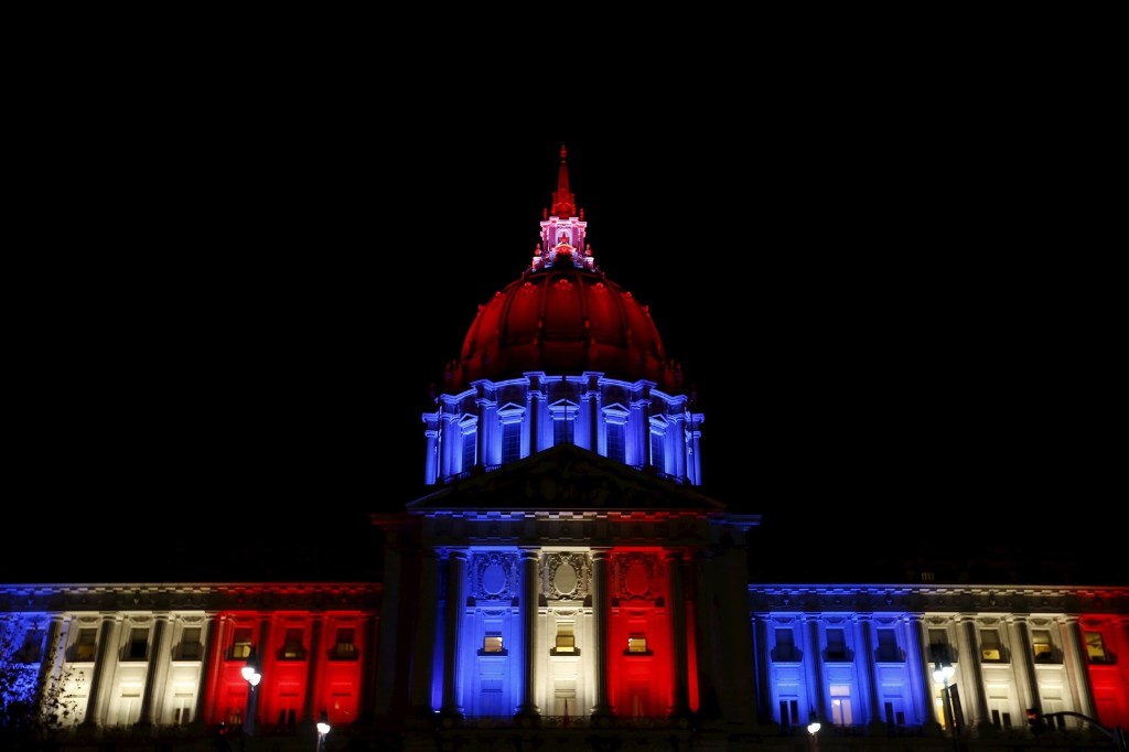 San Francisco City Hall is lit up with blue, white and red, the colors of the French flag.