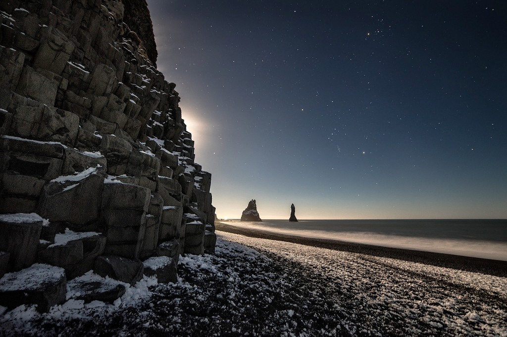 Moon lights up Reynisfjara Beach and the Basalt sea stacks in Iceland. Image: Ivan Pedretti
