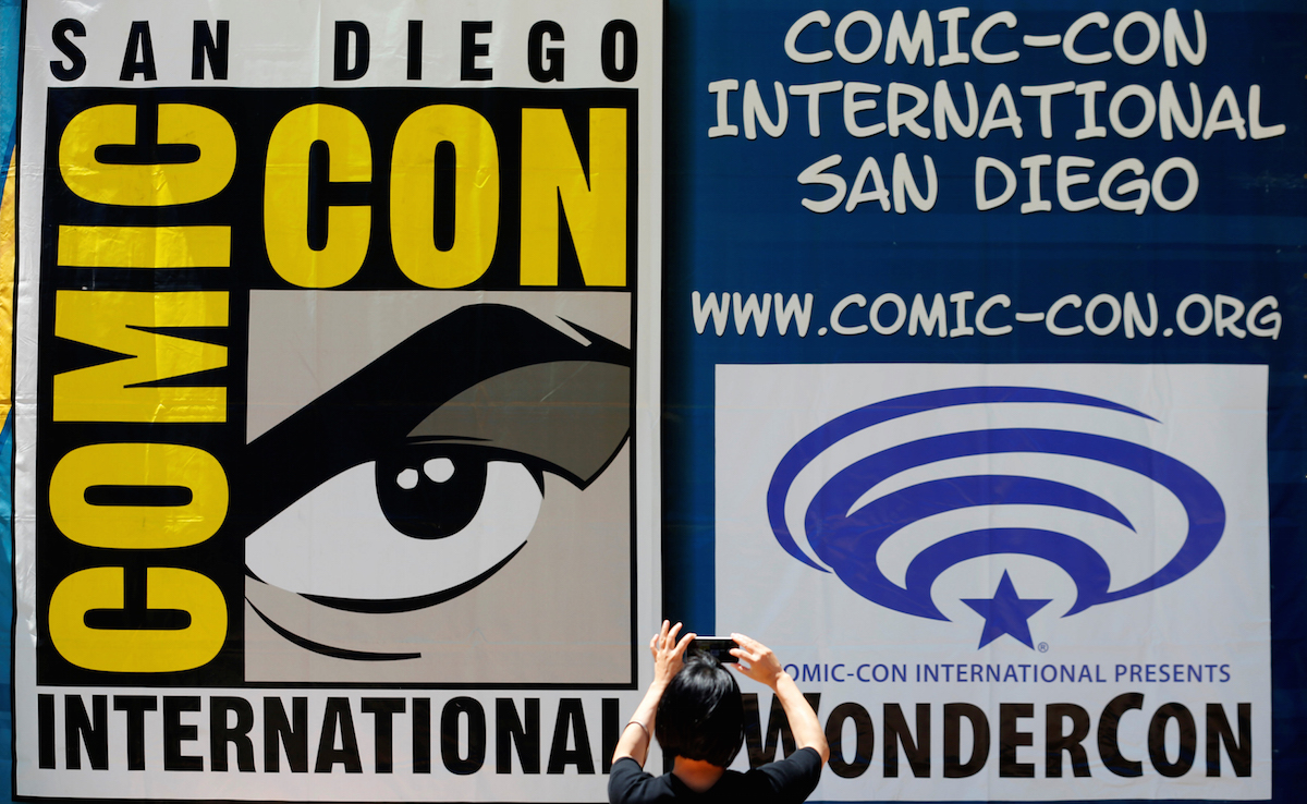 A woman takes a picture of a Comic-Con sign in San Diego, California United States, July 19, 2016. REUTERS/Mike Blake