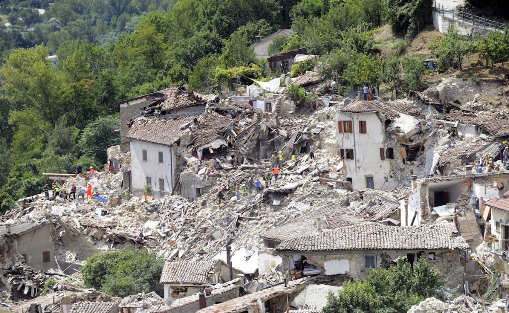 Rescuers search through debris of collapsed houses following an earthquake in Pescara del Tronto, Italy, Wednesday, Aug. 24, 2016. AP Photo/Sandro Perozzi
