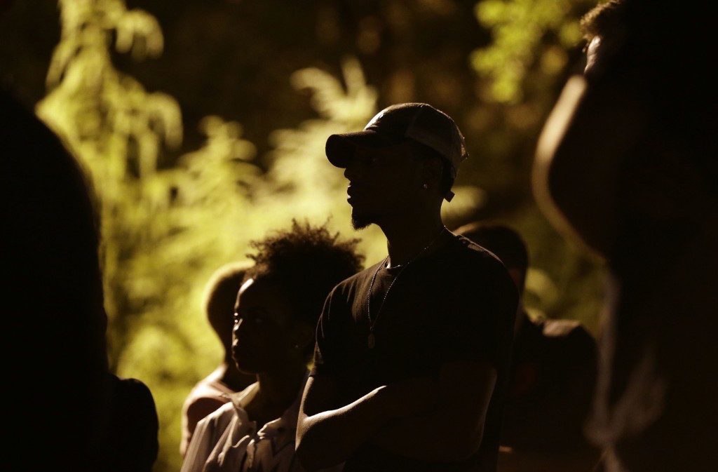 People gather for a vigil at the scene of Tuesday's police shooting of Keith Lamont Scott at The Village at College Downs apartment complex in Charlotte. AP Photo/Gerry Broome
