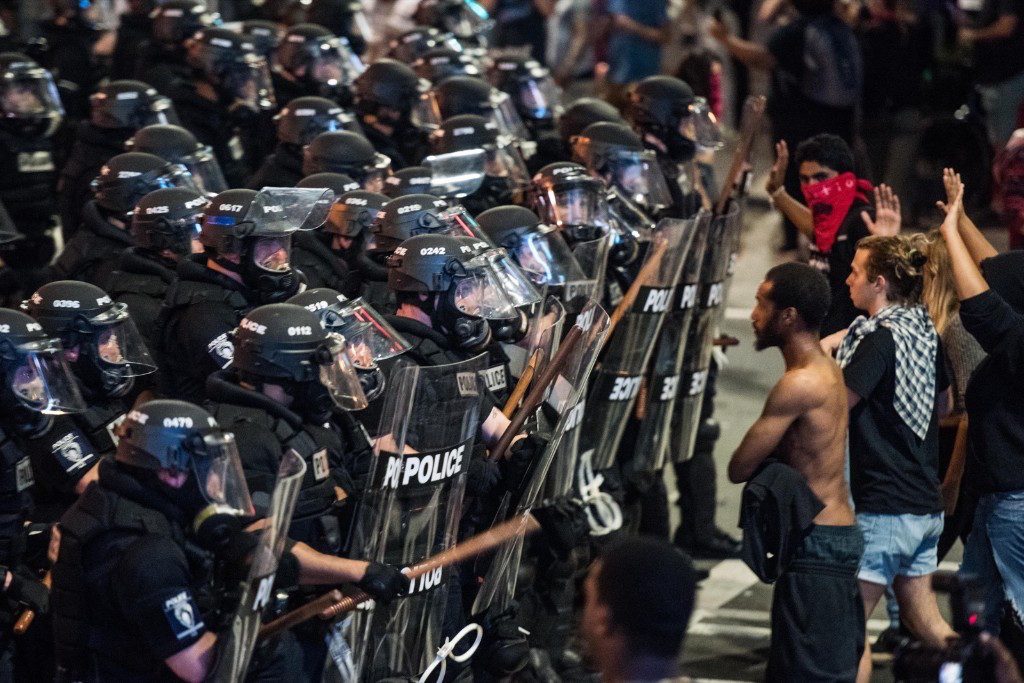 Police officers in riot gear approach demonstrators in downtown Charlotte. Sean Rayford/Getty Images