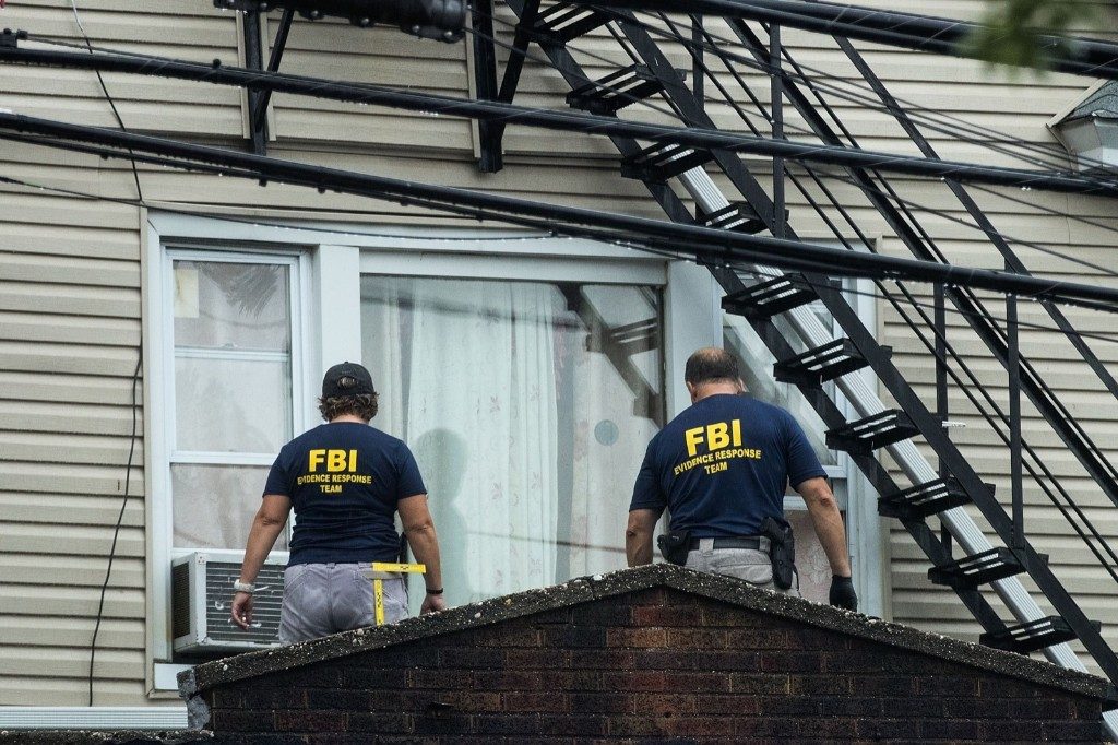 The FBI and other law enforcement officials investigate a residence in connection with the bombings in Elizabeth, N.J. Drew Angerer/Getty Images