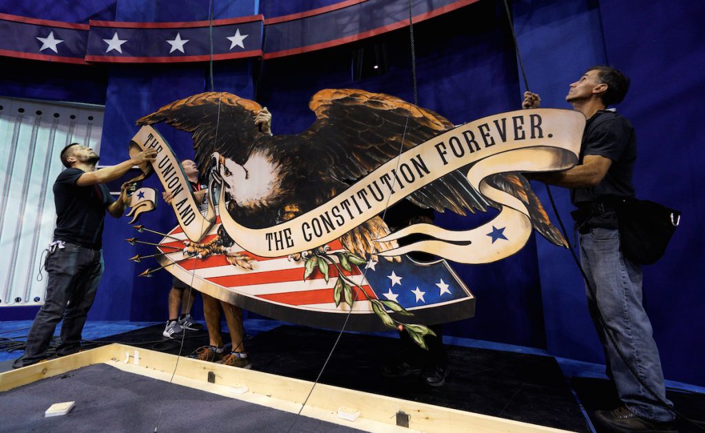 Workers install the eagle above the set for the last 2016 U.S. presidential debate in Las Vegas October 17, 2016. REUTERS/Rick Wilking