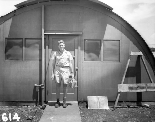 An unsettling picture of a US physicist cheerfully holding the 'Fat Man' atomic bomb's core