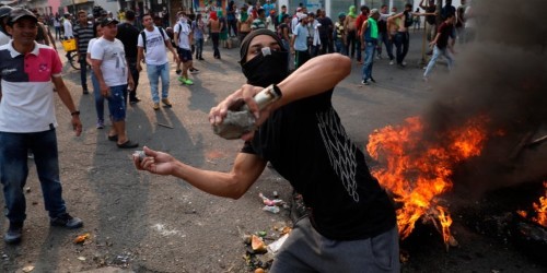 Photos show chaos in Venezuela as protesters and soldiers clash over humanitarian aid shipments