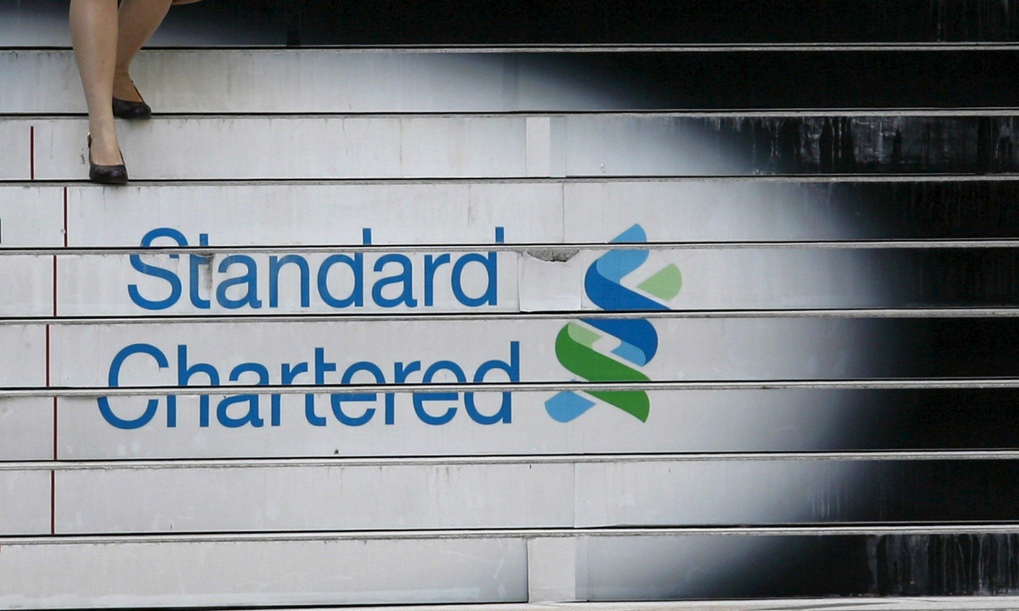 Standard Chartered shares surge despite profit slump