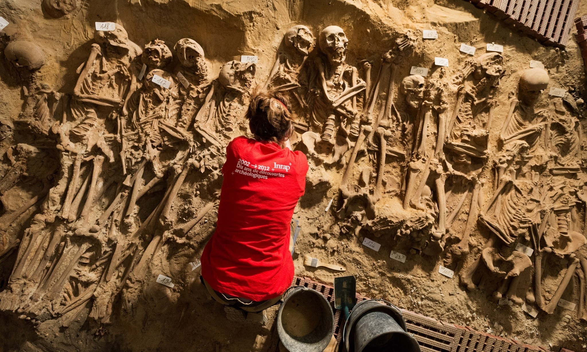 Parisians carry on shopping as mass graves are exhumed below their feet