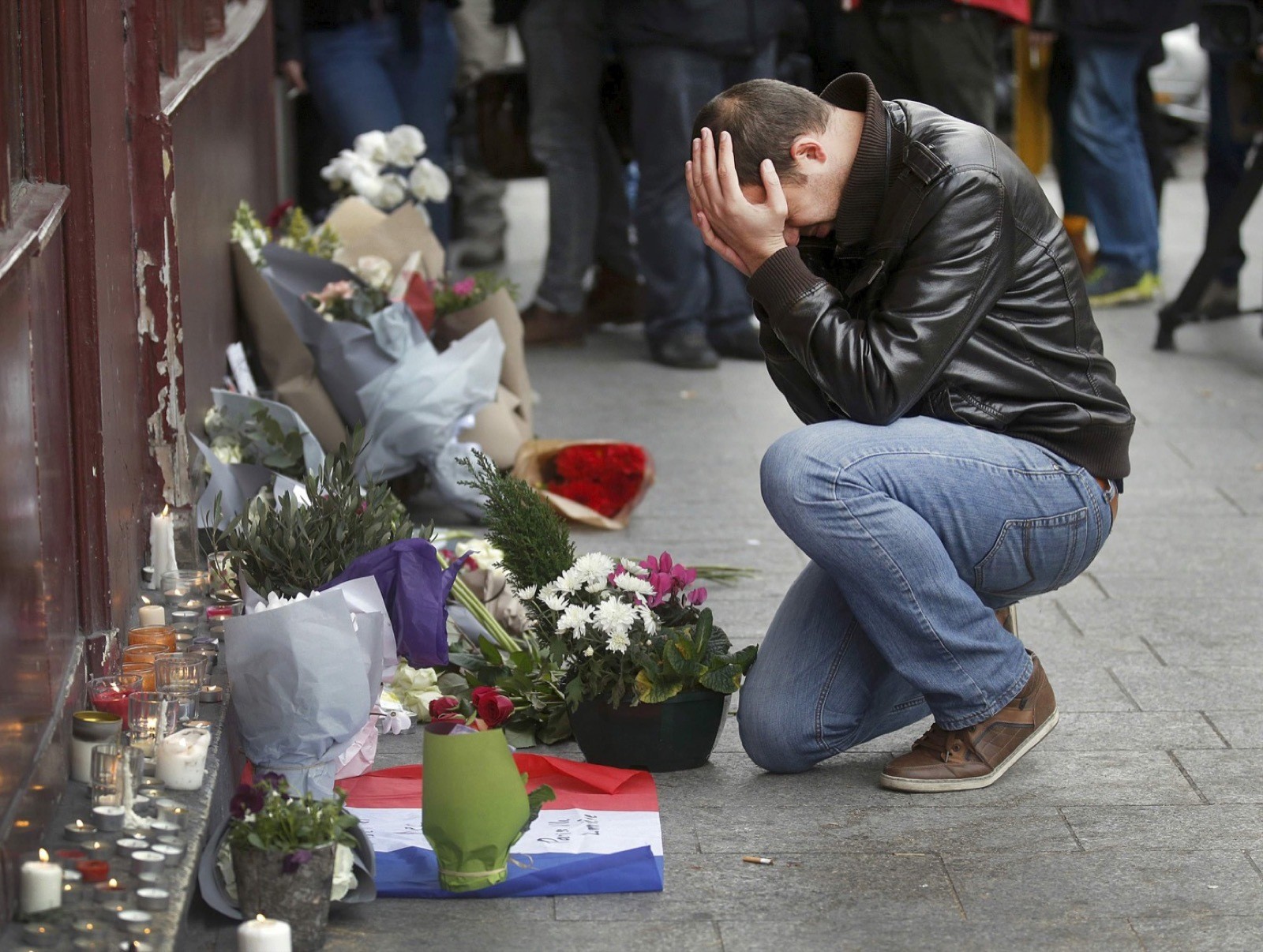 A man pays his respect outside Le Carillon restaurant the morning after a series of deadly attacks in Paris.