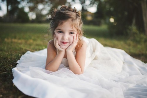 Little Girl Poses In Late Mother's Wedding Dress In Beautiful Photo Shoot