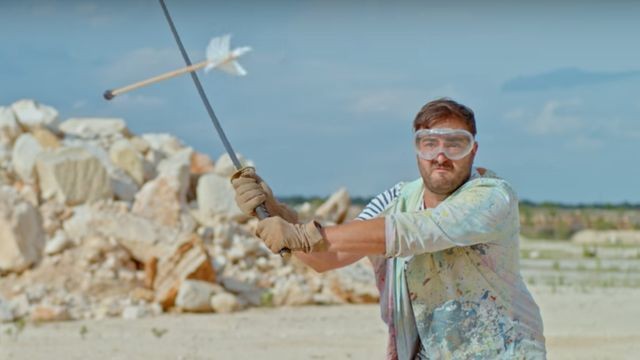 Man slices an arrow in half with a sword in glorious slow-motion