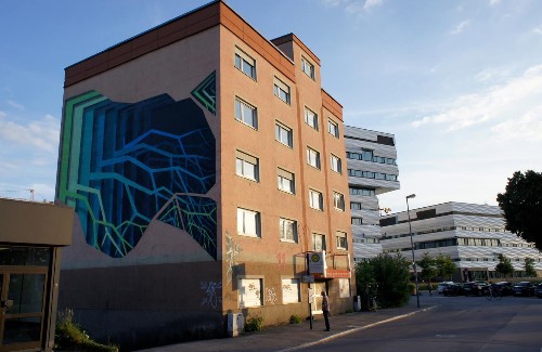 Street Artist Spray-Paints Colorful Optical Illusion Murals on Buildings