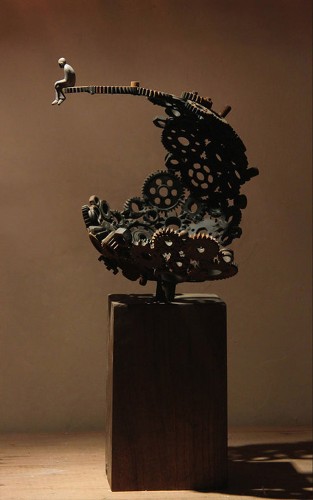 Man Sitting on Gears Symbolizes the Relationship Between Humans and Machines