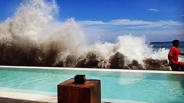 Bali tourists film giant waves crashing onto hotel poolside amid fears of 'tsunami'