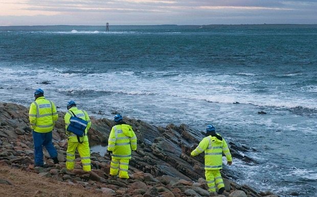 Hopes fade for crew of upturned cargo ship as search is suspended due to bad weather