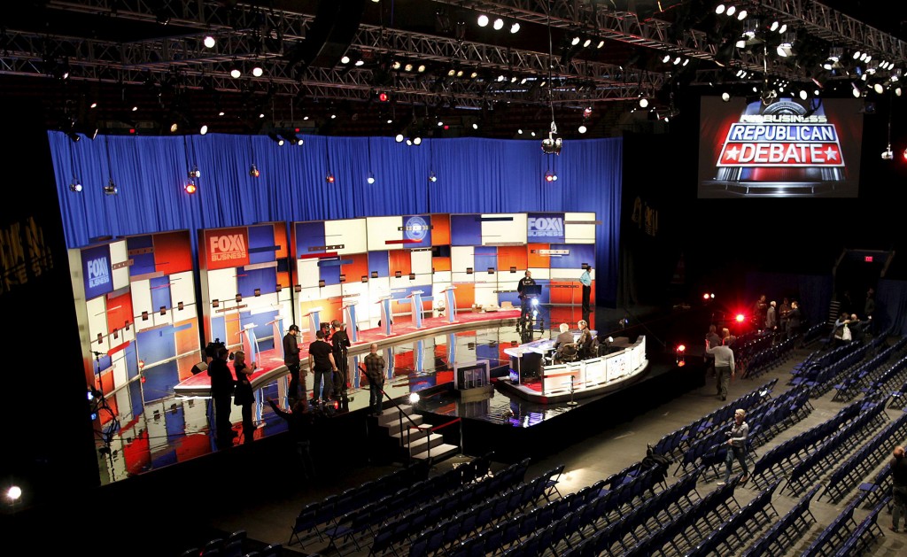 Crew members prepare the stage for Thursday's Fox Business Republican presidential debate at the North Charleston Coliseum. REUTERS/Randall Hill