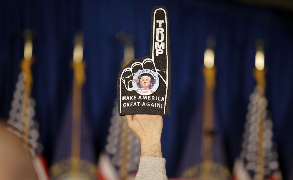 A supporter holds a foam finger sign promoting Republican presidential candidate businessman Donald Trump before he speaks at a primary night rally, Tuesday, Feb. 9, 2016, in Manchester, N.H. (AP Photo/David Goldman)