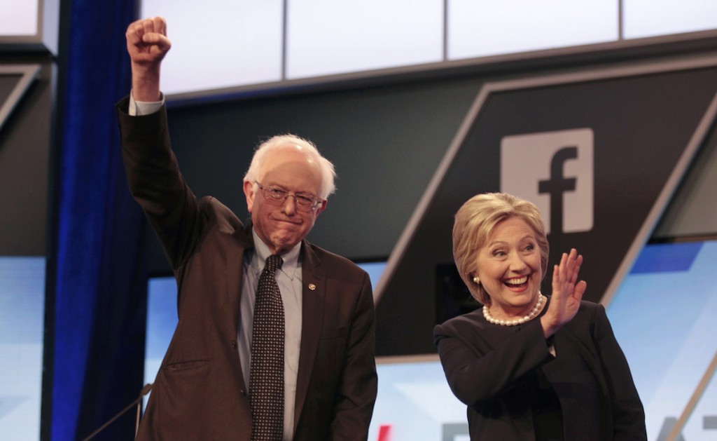 Bernie Sanders and Hillary Clinton wave before the start of the Univision News and Washington Post presidential debate in Kendall, Florida March 9, 2016.  REUTERS/Javier Galeano