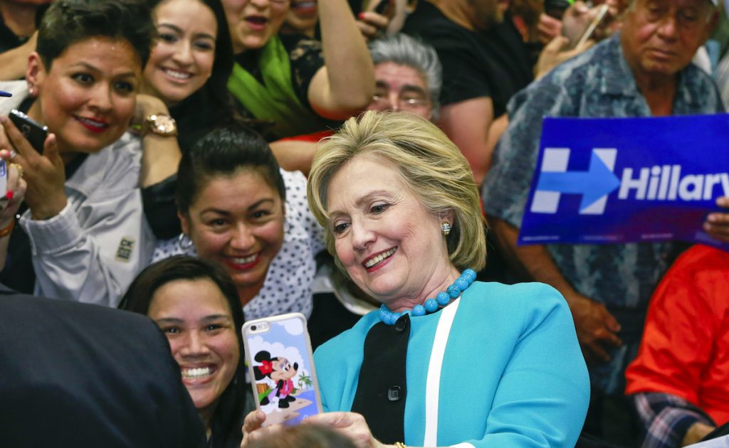 Hillary Clinton takes a photo with supporters at the end of a campaign stop at East Los Angeles College in Los Angeles. (AP Photo/Damian Dovarganes)
