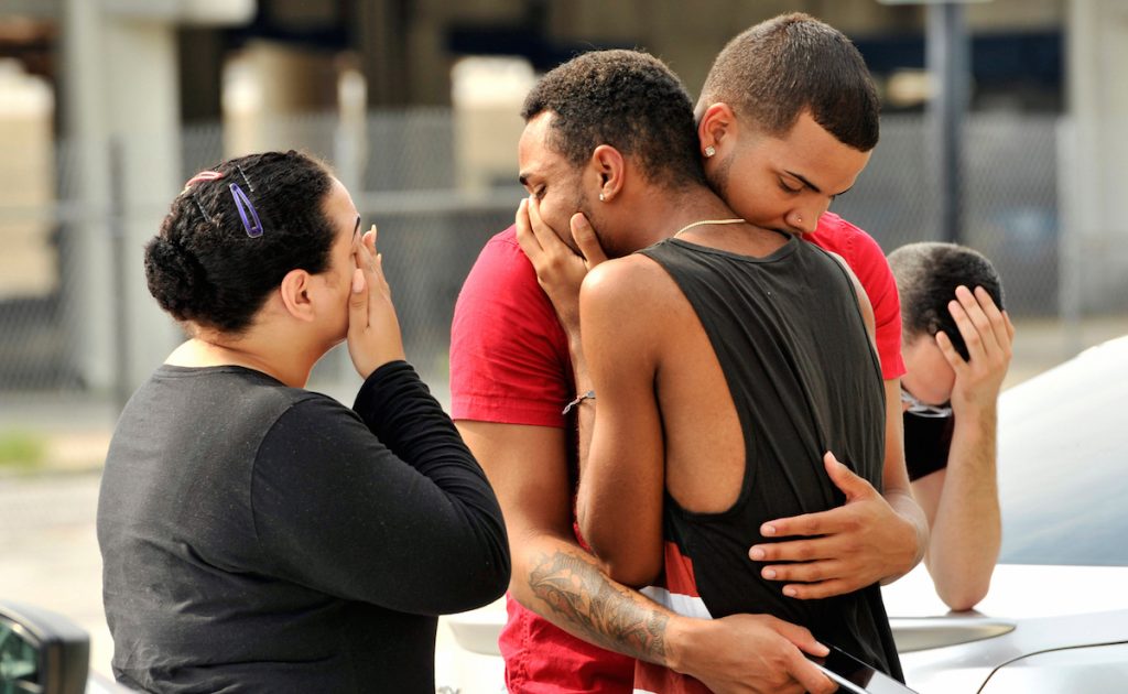 Friends and family members embrace outside the Orlando Police Headquarters during the investigation of a shooting at the Pulse night club in Orlando, Florida. U.S June 12, 2016.  REUTERS/Steve Nesius