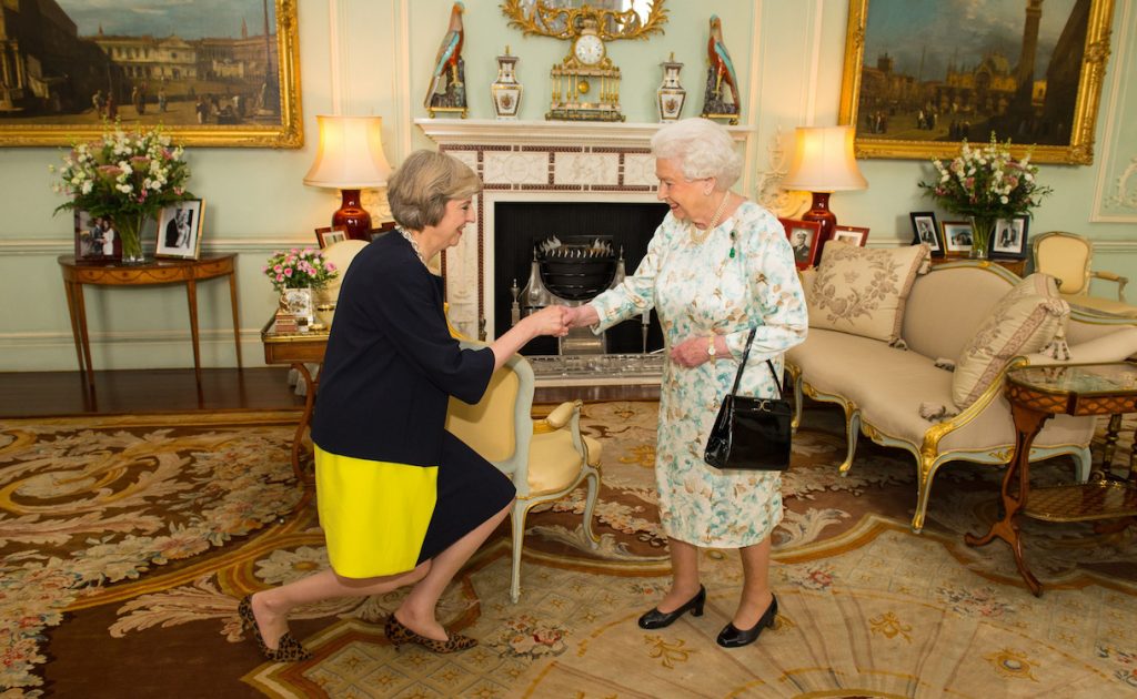 Queen Elizabeth II welcomes Theresa May, left, at the start of an audience in Buckingham Palace, London, where she invited the former Home Secretary to become Prime Minister and form a new government, Wednesday July 13, 2016. David Cameron had resigned the post in an earlier meeting with the queen. (Dominic Lipinski/Pool Photo via AP)