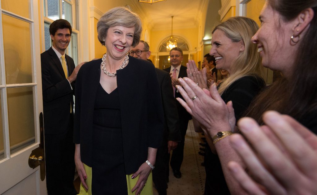 LONDON, UNITED KINGDOM - JULY 13: New Prime Minister Theresa May, followed by her husband Philip John, is welcomed by staff as she walks into 10 Downing Street after meeting Queen Elizabeth II and accepting her invitation to become Prime Minister and form a new government on July 13, 2016 in London, United Kingdom. Former Home Secretary Theresa May becomes the UK's second female Prime Minister after she was selected unopposed by Conservative MPs to be their new party leader. She is currently MP for Maidenhead. (Photo by Stefan Rousseau - WPA Pool/Getty Images)