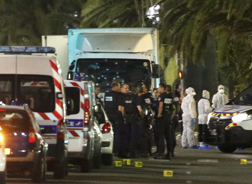French police forces and forensic officers stand next to a truck that ran into a crowd celebrating the Bastille Day national holiday in Nice. REUTERS/Eric Gaillard