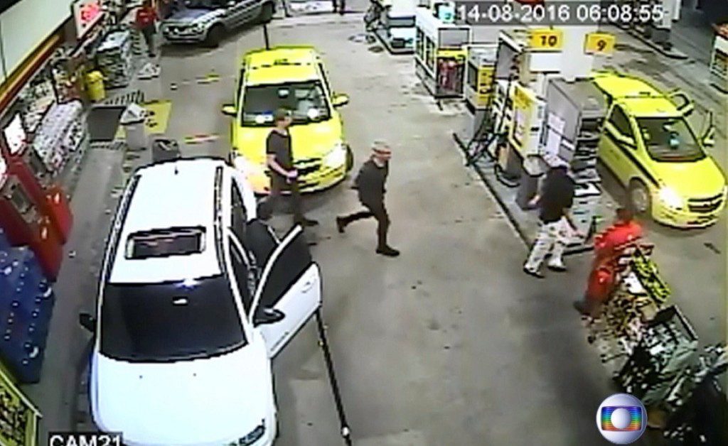 Security video shows three U.S. Olympic swimmers returning to their taxi at a gasoline station where they were accused by staff of having caused damage. Globo TV via Reuters