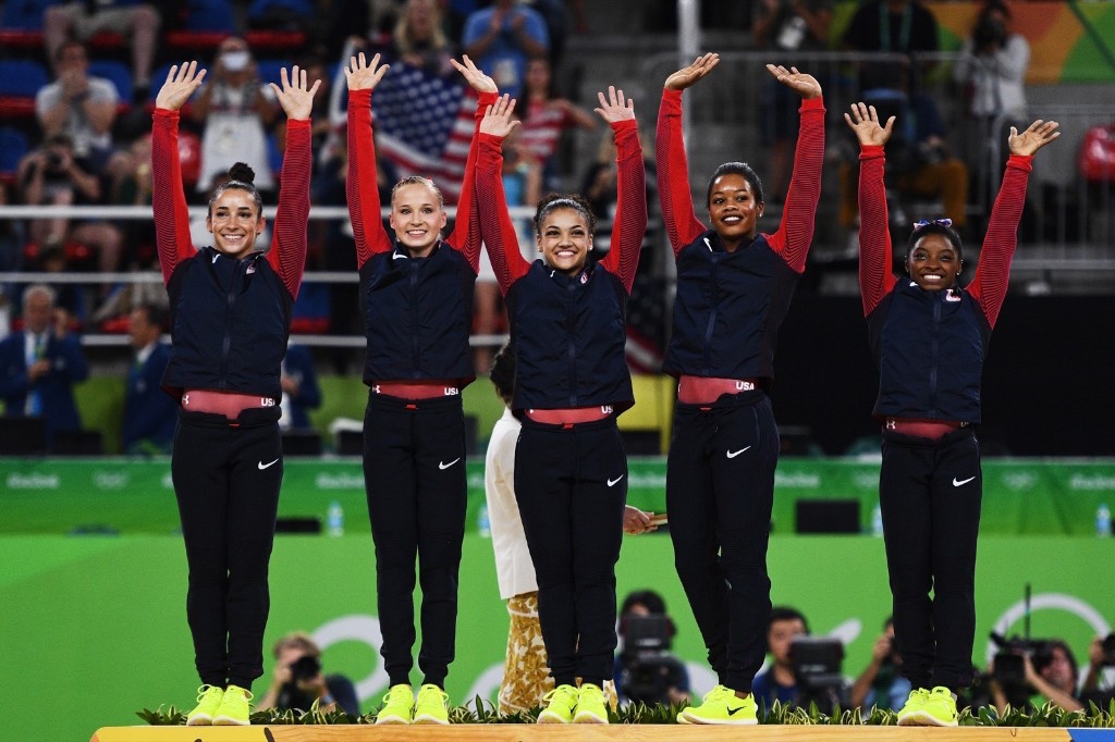 Gold Medalists Simone Biles, Gabby Douglas, Laurie Hernandez, Madison Kocian and Aly Raisman celebrate on the podium at the medal ceremony. David Ramos/Getty Images