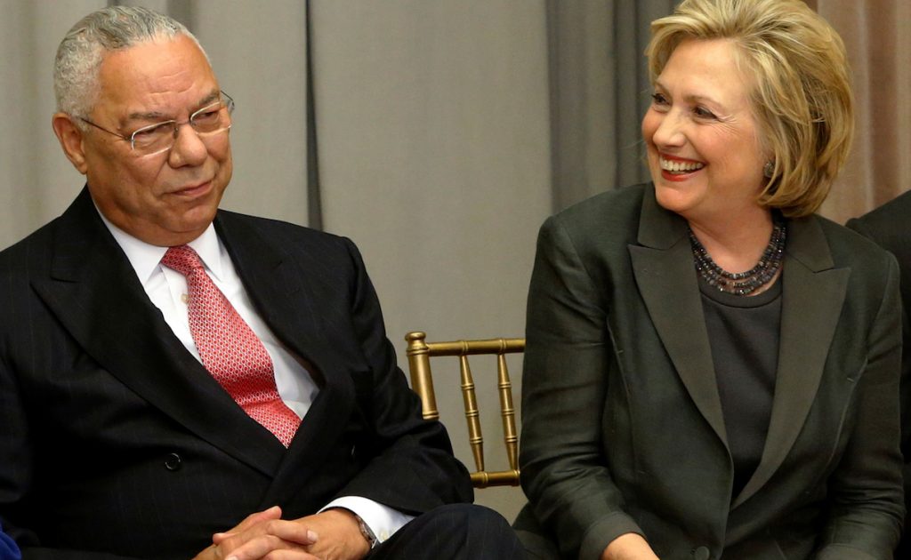 Former U.S. Secretaries of State Colin Powell (L) and Hillary Clinton listen to remarks at a groundbreaking ceremony for the U.S. Diplomacy Center in Washington September 3, 2014. REUTERS/Jonathan Ernst/File Photo