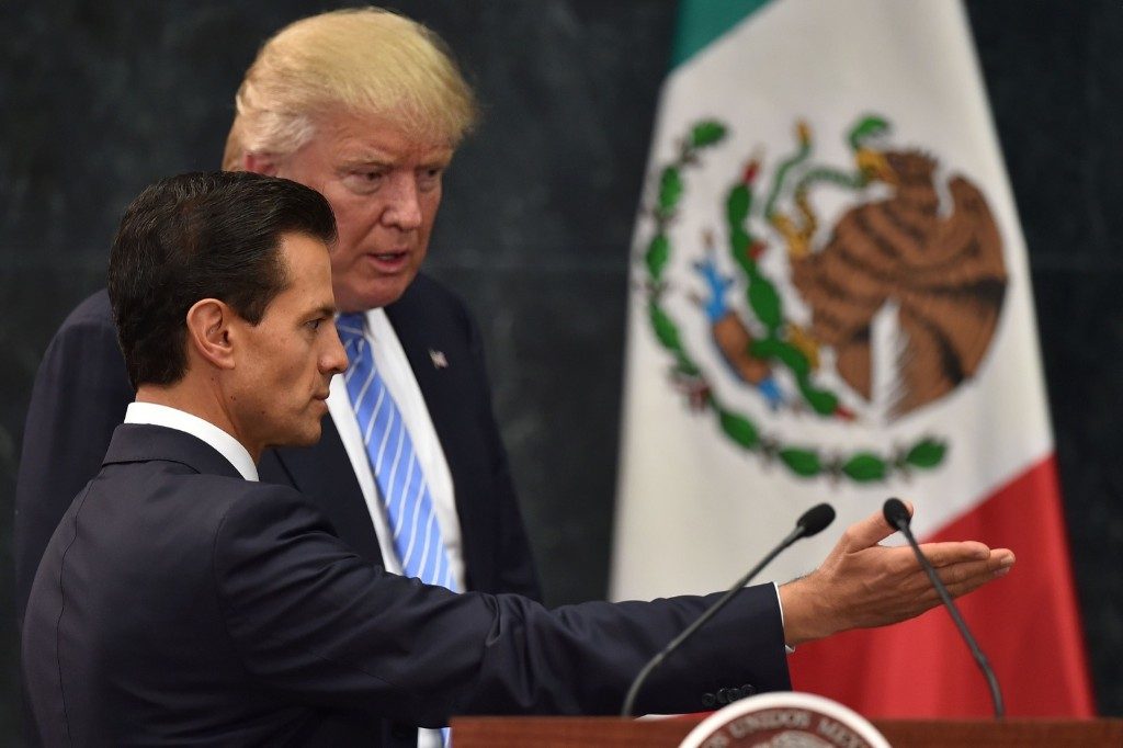 Donald Trump and Mexican President Enrique Pena Nieto prepare to deliver a joint press conference in Mexico City. YURI CORTEZ/AFP/Getty Images