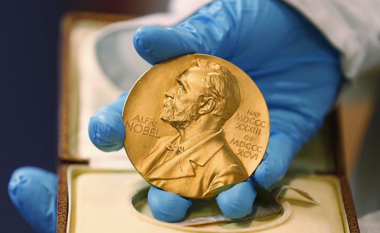 FILE- In this file photo dated Friday, April 17, 2015, a national library employee shows the gold Nobel Prize medal awarded to the late novelist Gabriel Garcia Marquez, in Bogota, Colombia. There is no bigger international honor than the Nobel Prize, created by 19th-century Swedish industrialist Alfred Nobel, and the 2016 laureates will be named over the coming days to join the pantheon of greats who were honored in years gone by. (AP Photo/Fernando Vergara, FILE)