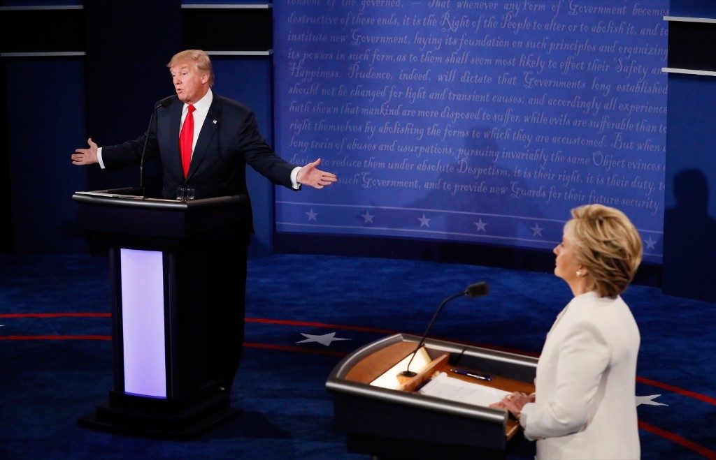 Donald Trump speaks as Hillary Clinton looks on. Pool/Getty Images