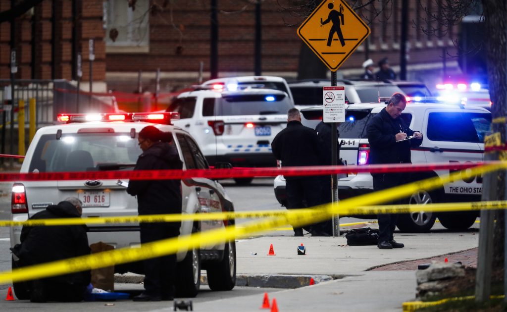 Crime scene investigators collect evidence from the pavement as police respond to an attack on campus at Ohio State University, in Columbus, Ohio. AP Photo/John Minchillo, File