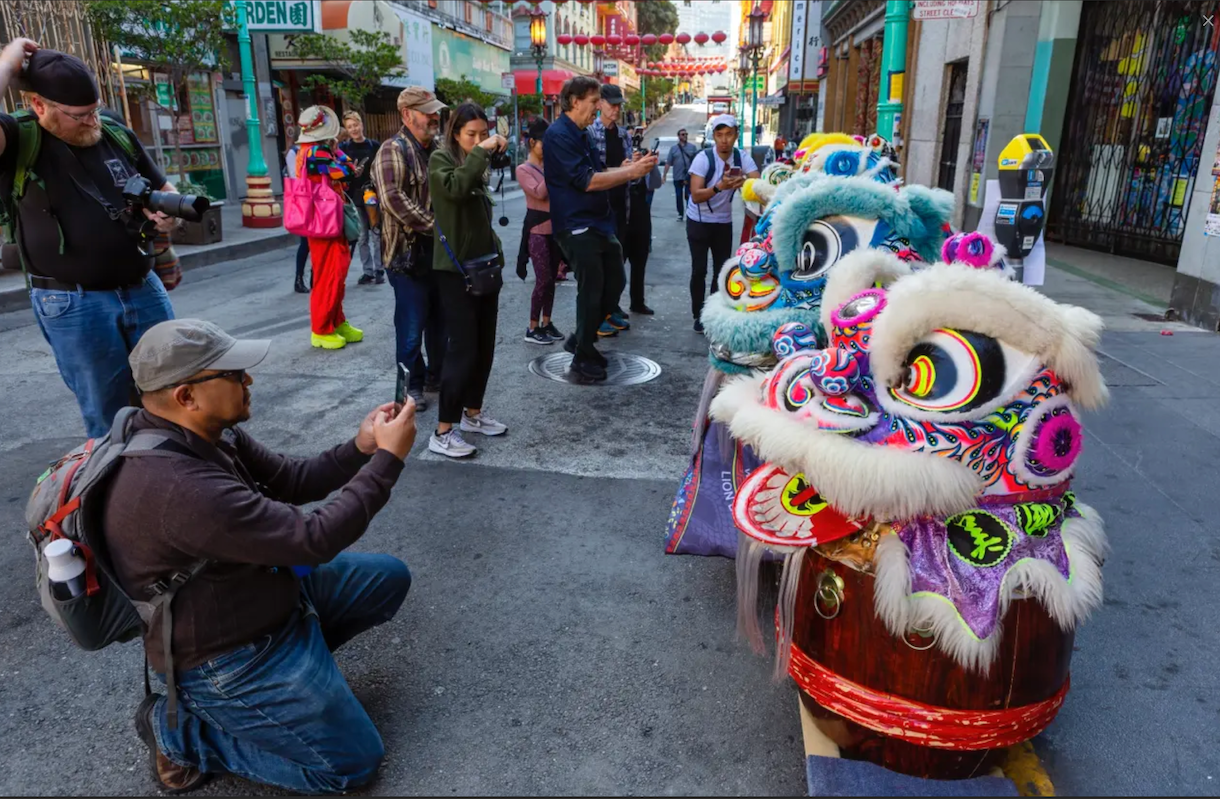 Photowalkers taking photos of dragon heads in San Francisco's Chinatown