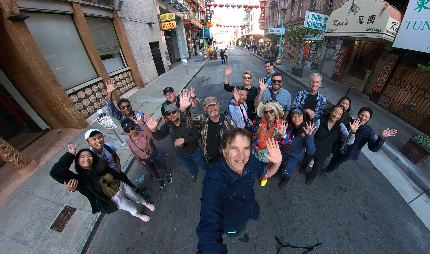 Jefferson Graham taking a wide angle selfie with a group of photowalkers waving at the camera. 