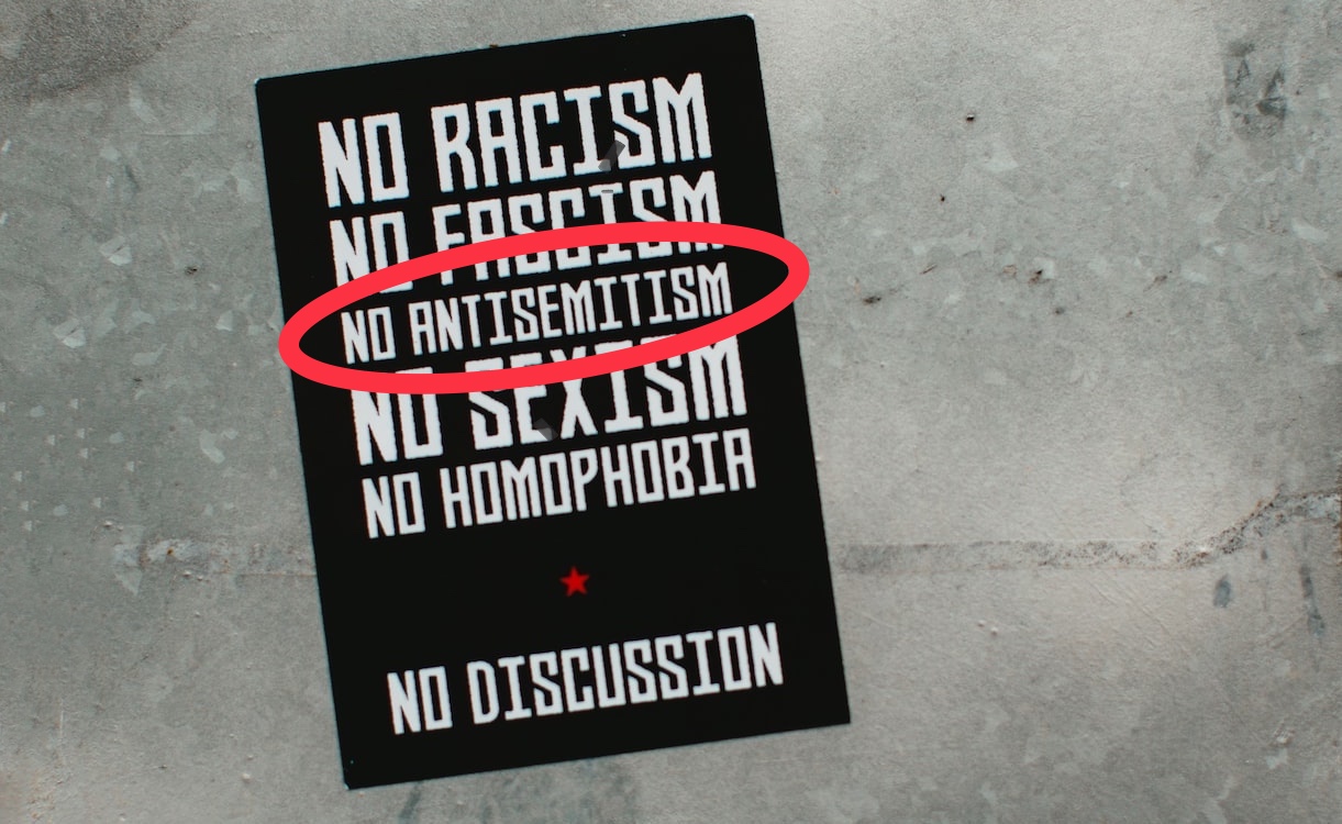 A black pamphlet with the words "no racism, no fascism, no antisemitism, no sexism, no homophone, no dissuasion; no antisemitism is circled in red. 